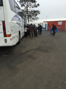 Migrants filing from a rest tent onto the bus to continue their journey onto Austria